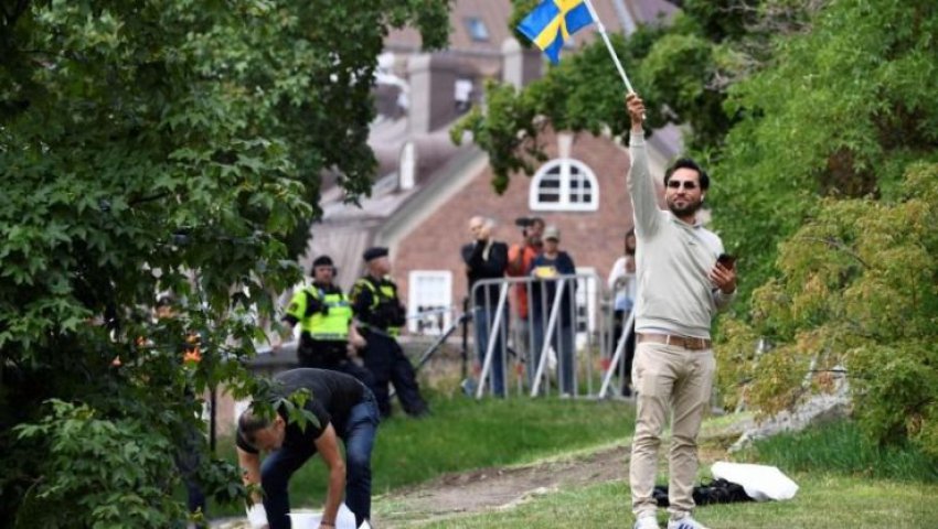 Salwan Momika brandissant un drapeau suédois lors d'une manifestation devant l'ambassade d'Irak à Stockholm, Suède, le 20 juillet